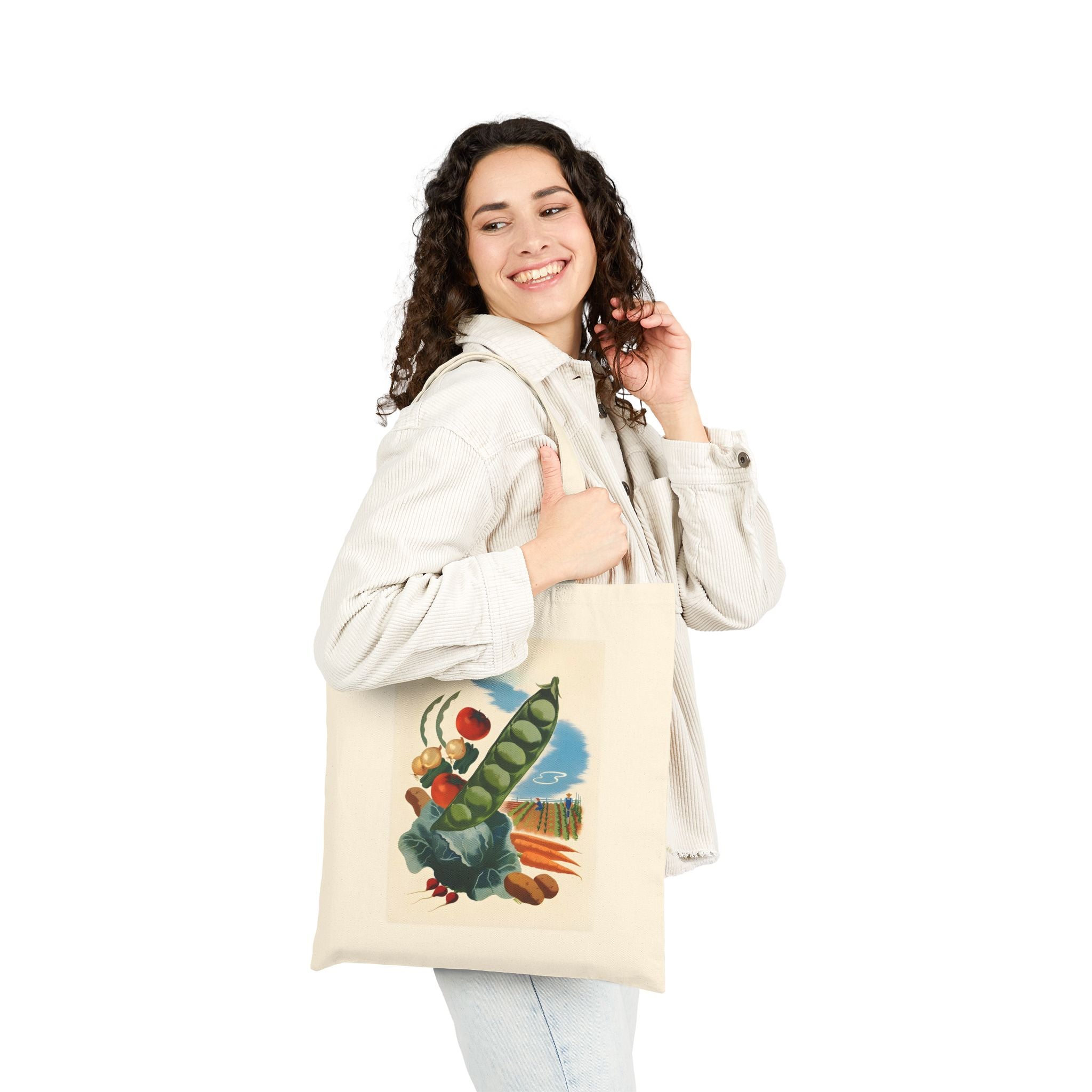 Woman smiling while holding an old-fashioned grocery tote bag featuring colorful produce graphics.