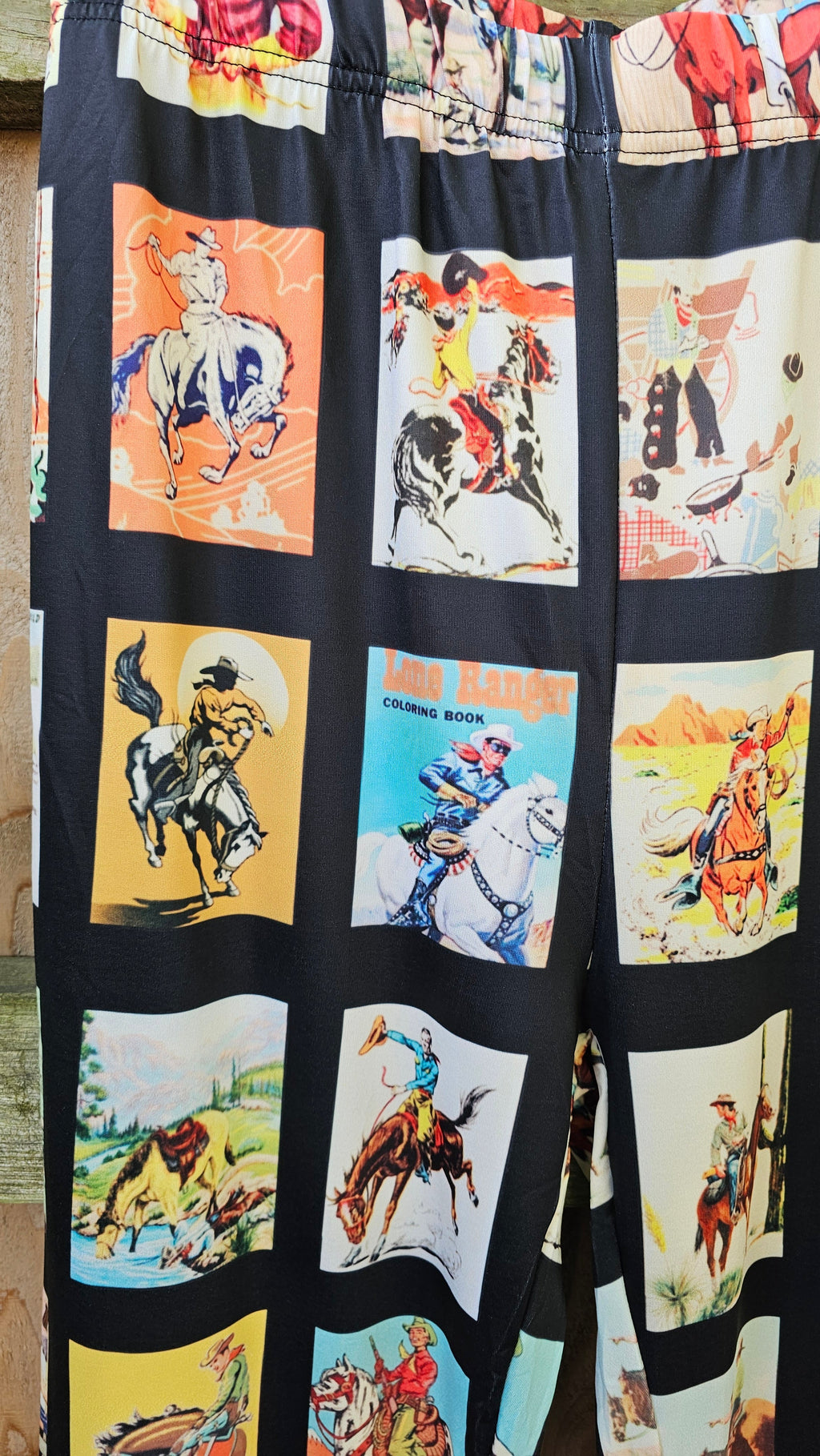 Vintage cowboy collage print on Western flare pants featuring rodeo and cowboy graphics.