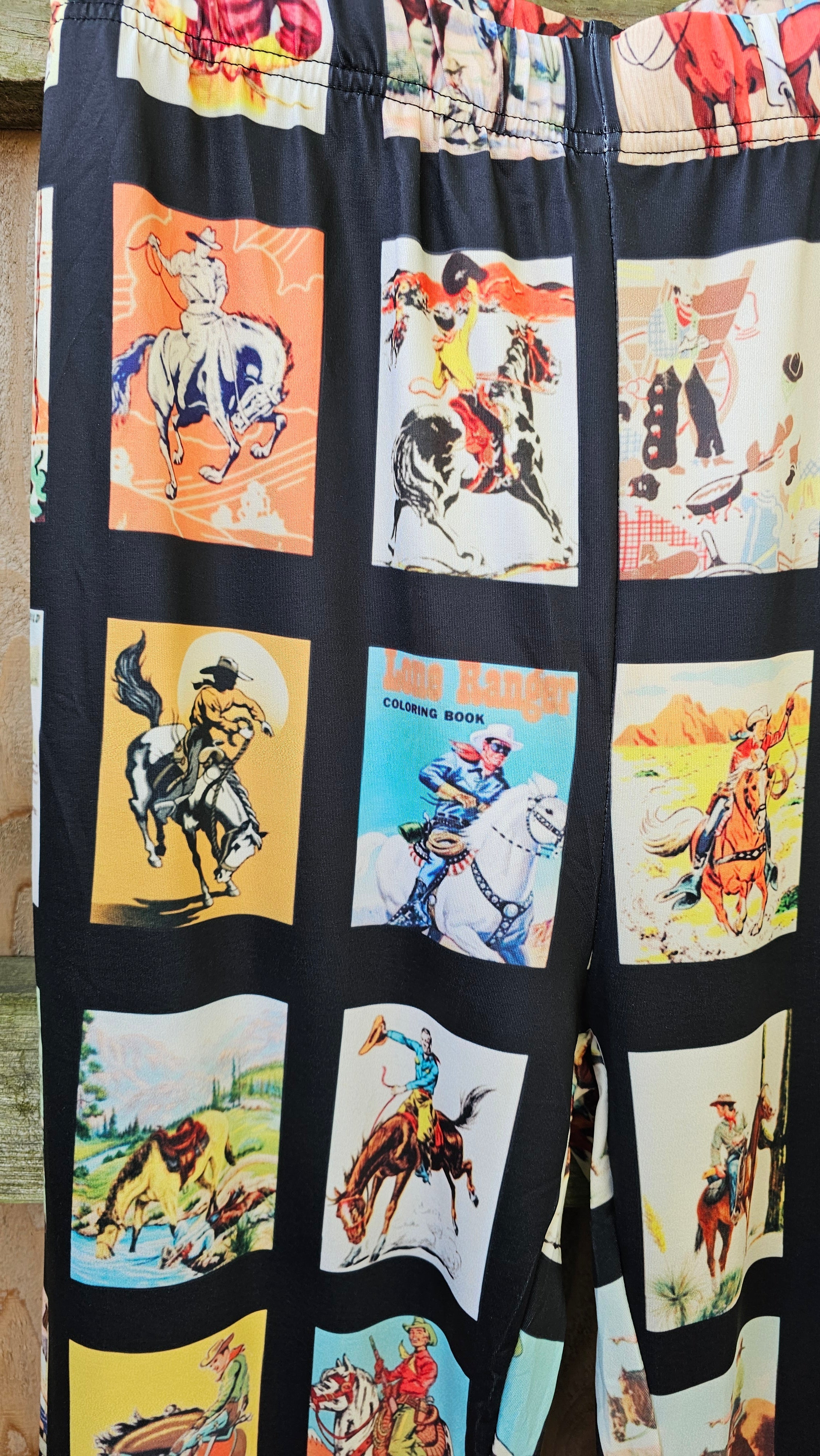 Vintage cowboy collage print on Western flare pants featuring rodeo and cowboy graphics.