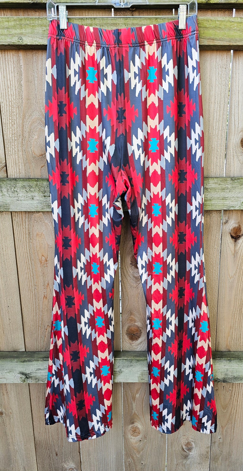 Sedona Aztec Flare Pants featuring vibrant red, black, and teal geometric patterns, perfect for stylish and comfortable wear.