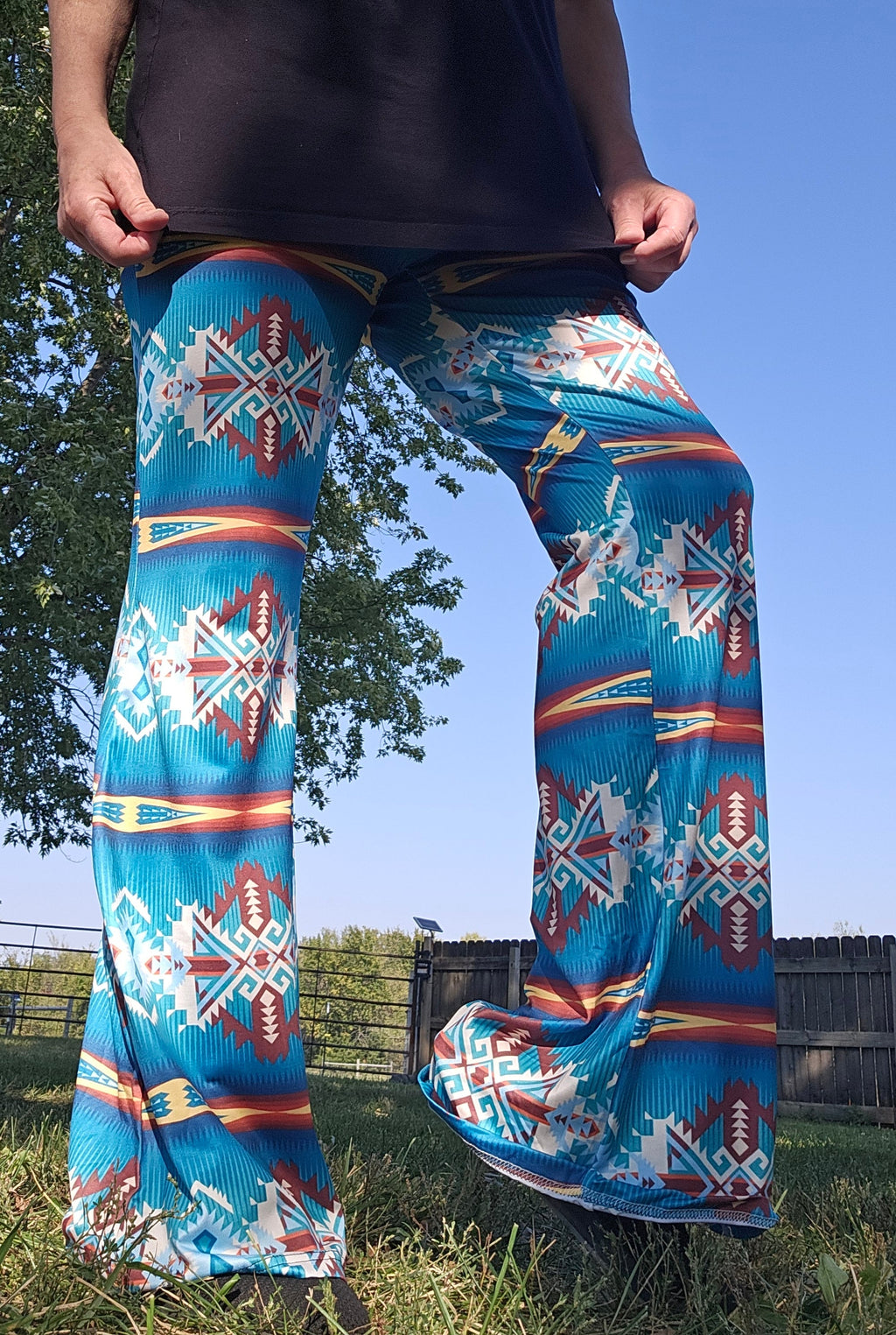 Teal Aztec flare pants featuring a bold southwestern print, perfect for festival wear and modern comfort.