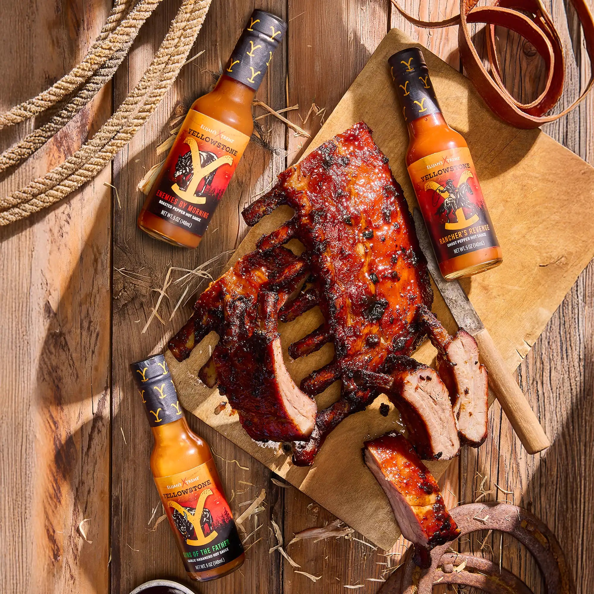 Delicious ribs glazed with Yellowstone hot sauces, showcasing the flavors of Enemies by Morning and Spicy Pepper sauces.