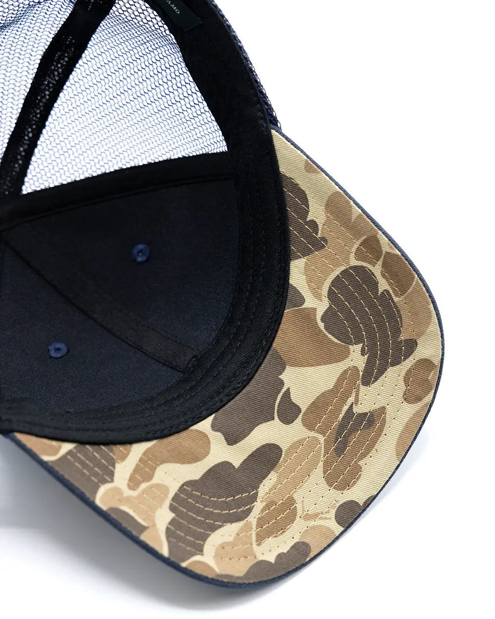 Close-up of the Arthur Core Snapback Hat showcasing its camo-pattern brim and breathable mesh design.