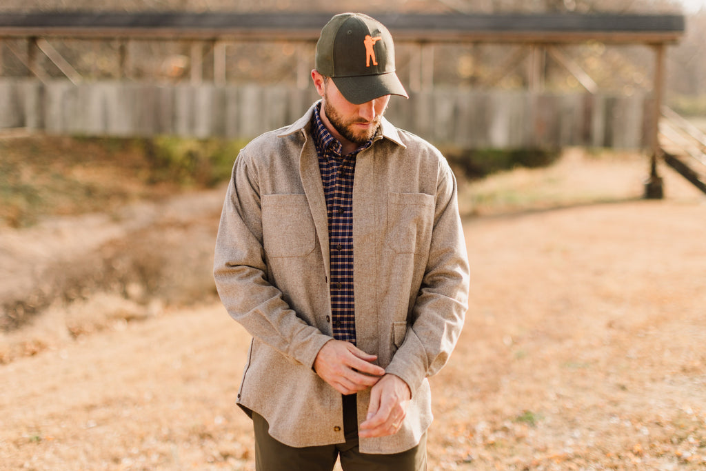 Man wearing Arthur Core Snapback Hat with a casual outfit in a natural outdoor setting.
