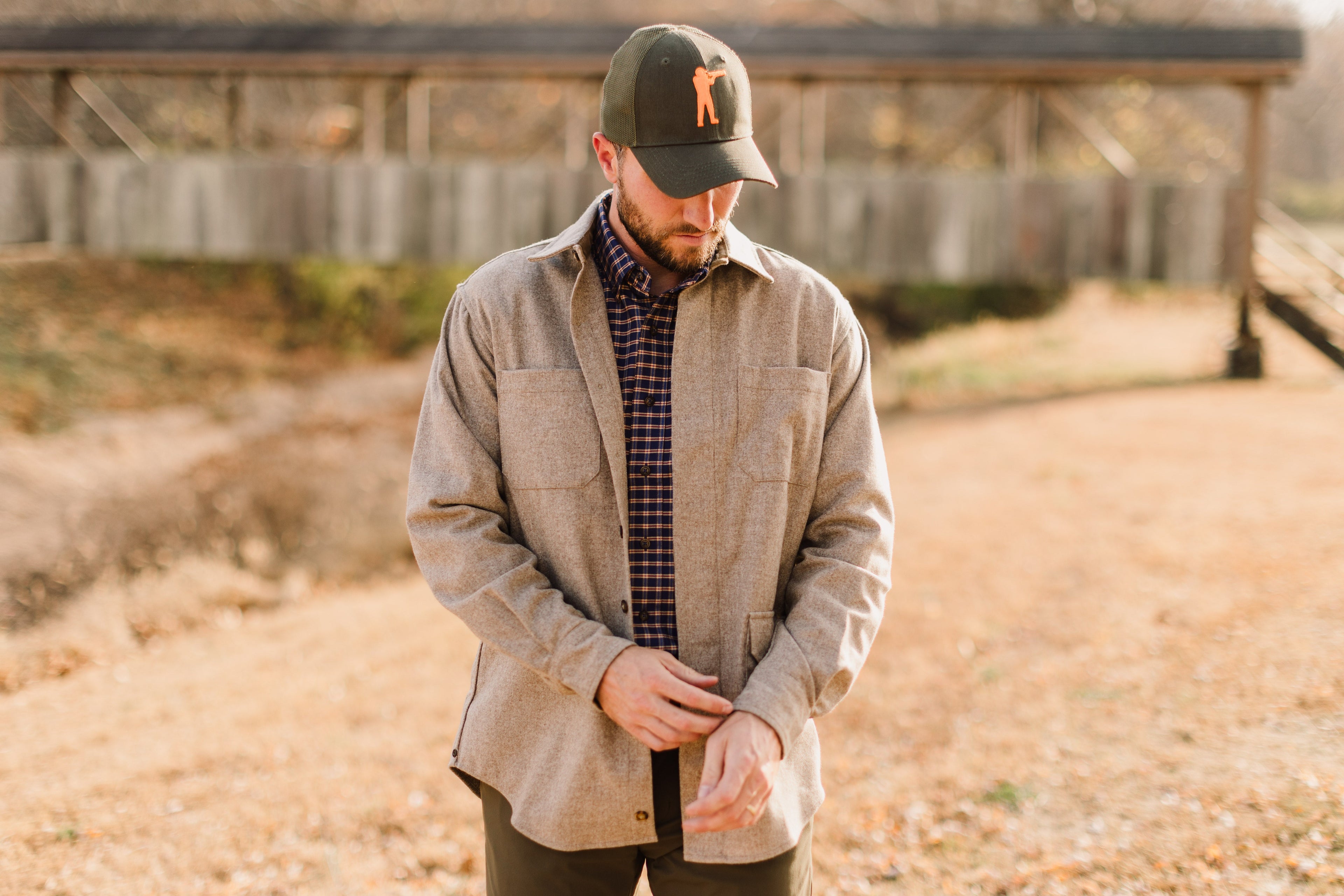 Man wearing Arthur Core Snapback Hat with a casual outfit in a natural outdoor setting.