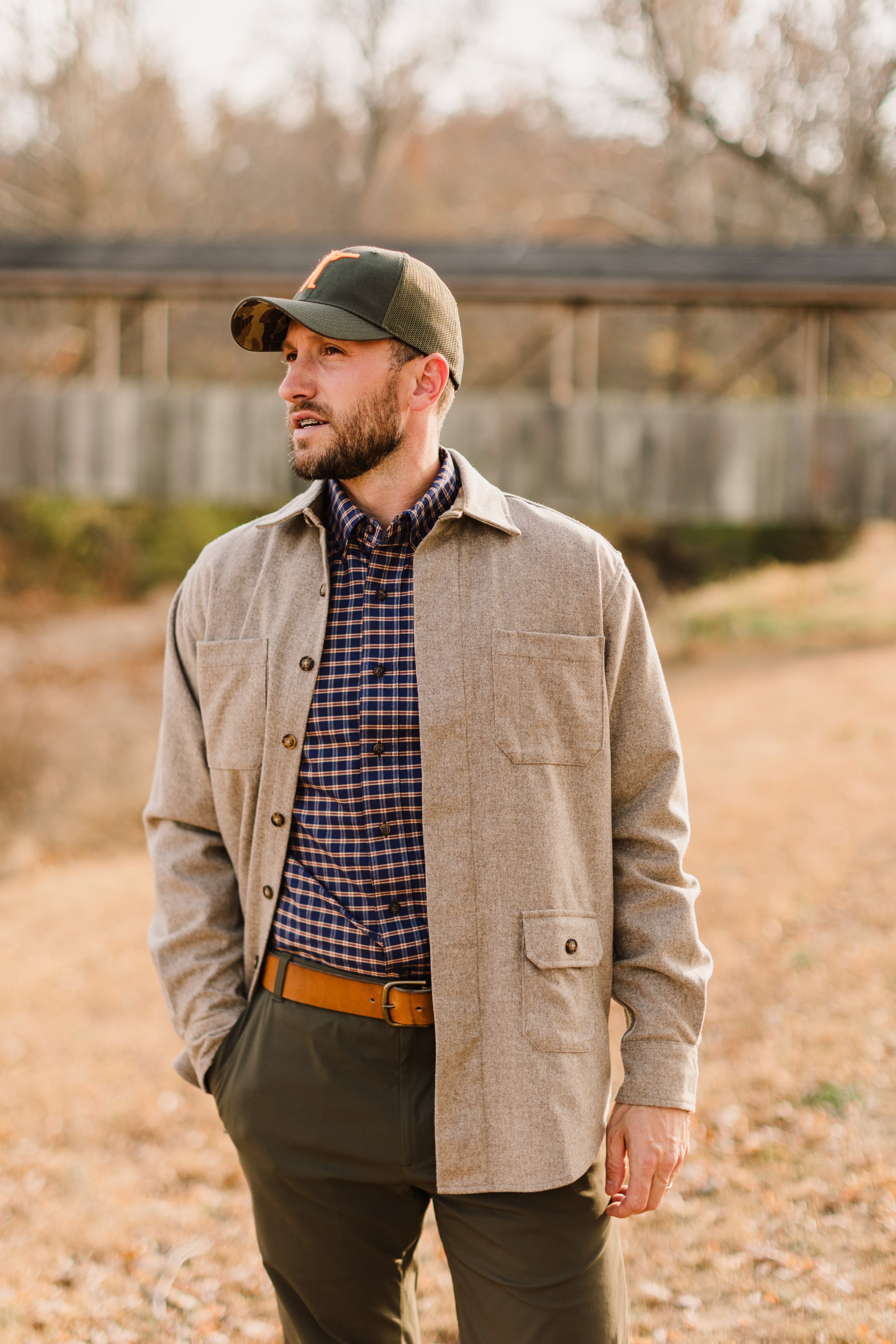 Man wearing an Arthur Core Snapback Hat and stylish layer on a fall day outdoors.