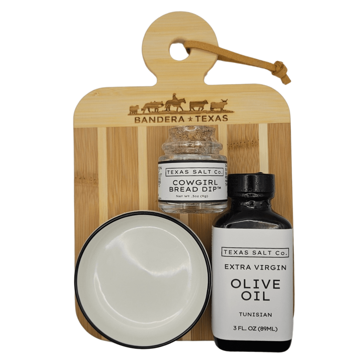 Delicious bread dip gift set with cowgirl dip, extra virgin olive oil, and dipping bowl on a bamboo board.