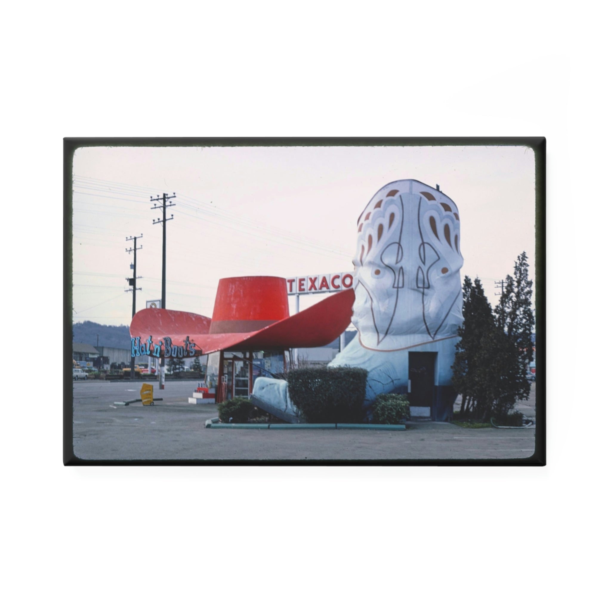 Unique Texaco gas station featuring a giant cowboy boot as a building structure in a retro setting.