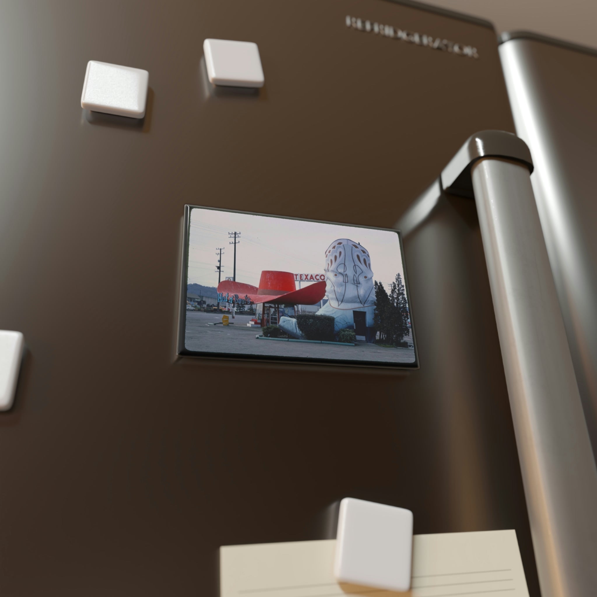 Fridge magnet showcasing a retro Texaco gas station image on a modern refrigerator.