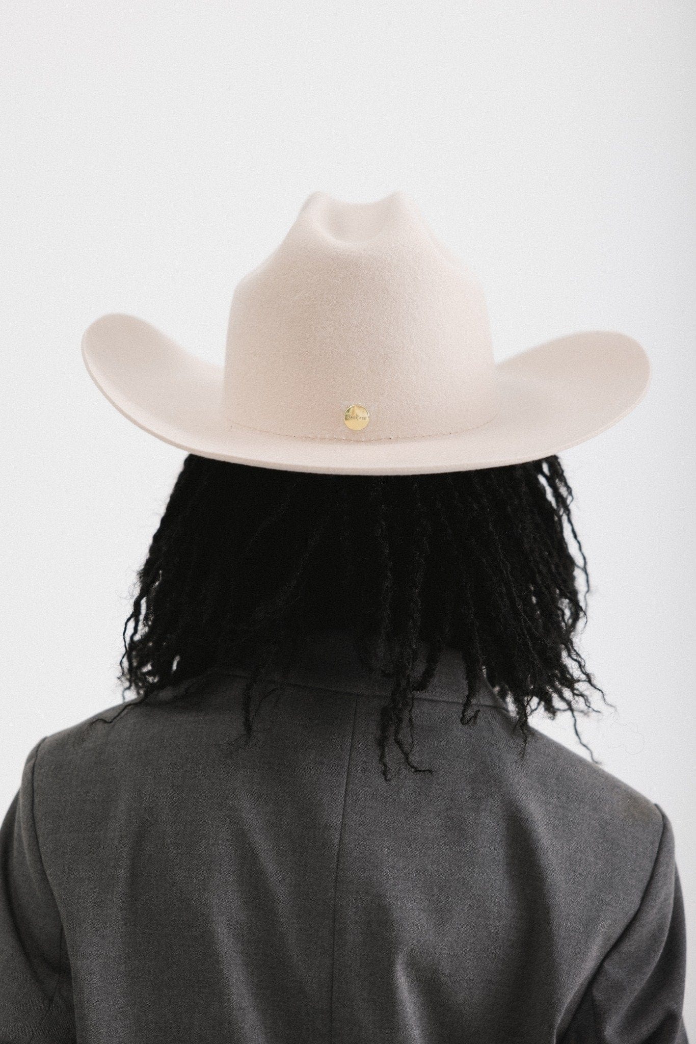 Back view of a woman in a felt Teddy Cattleman cowboy hat, showcasing classic western style.