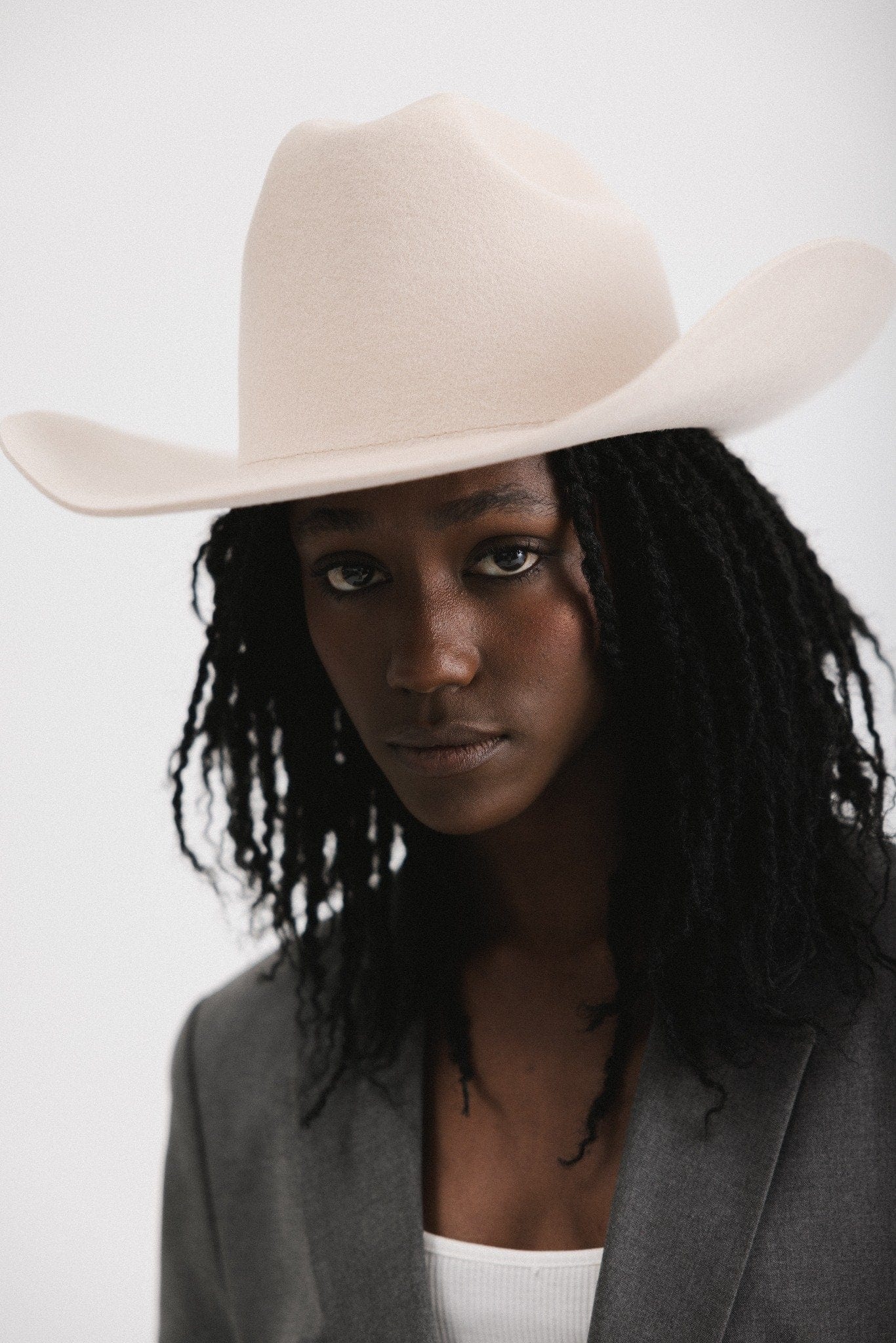 Model wearing a stylish Teddy Cattleman cowboy hat, showcasing bold western fashion elegance.