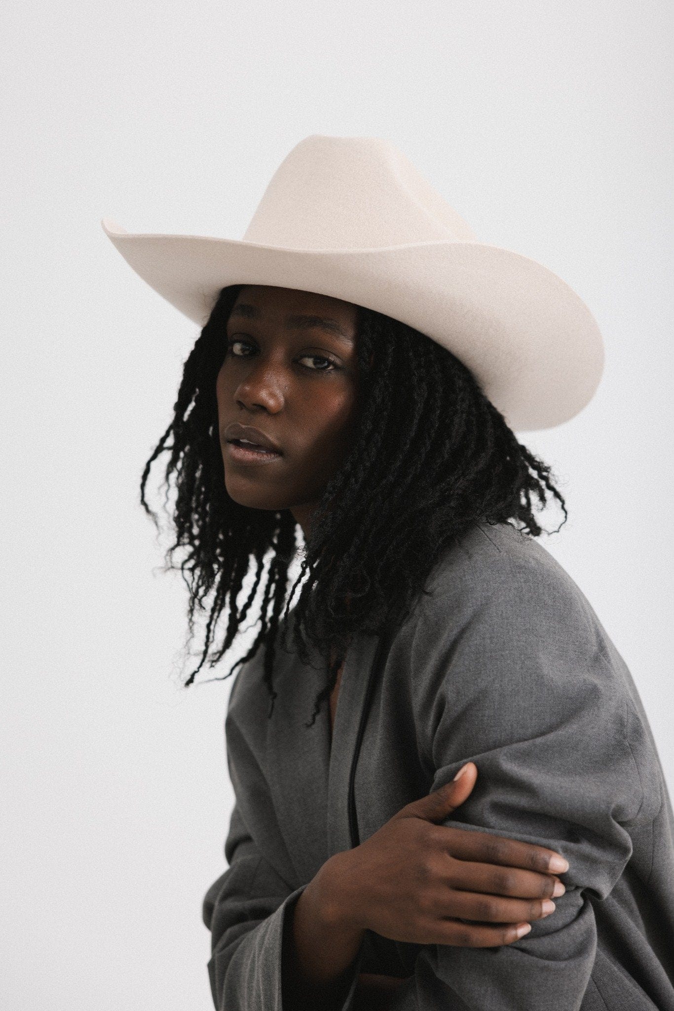 Fashionable model wearing a Teddy Cattleman cowboy hat with a classic western style.
