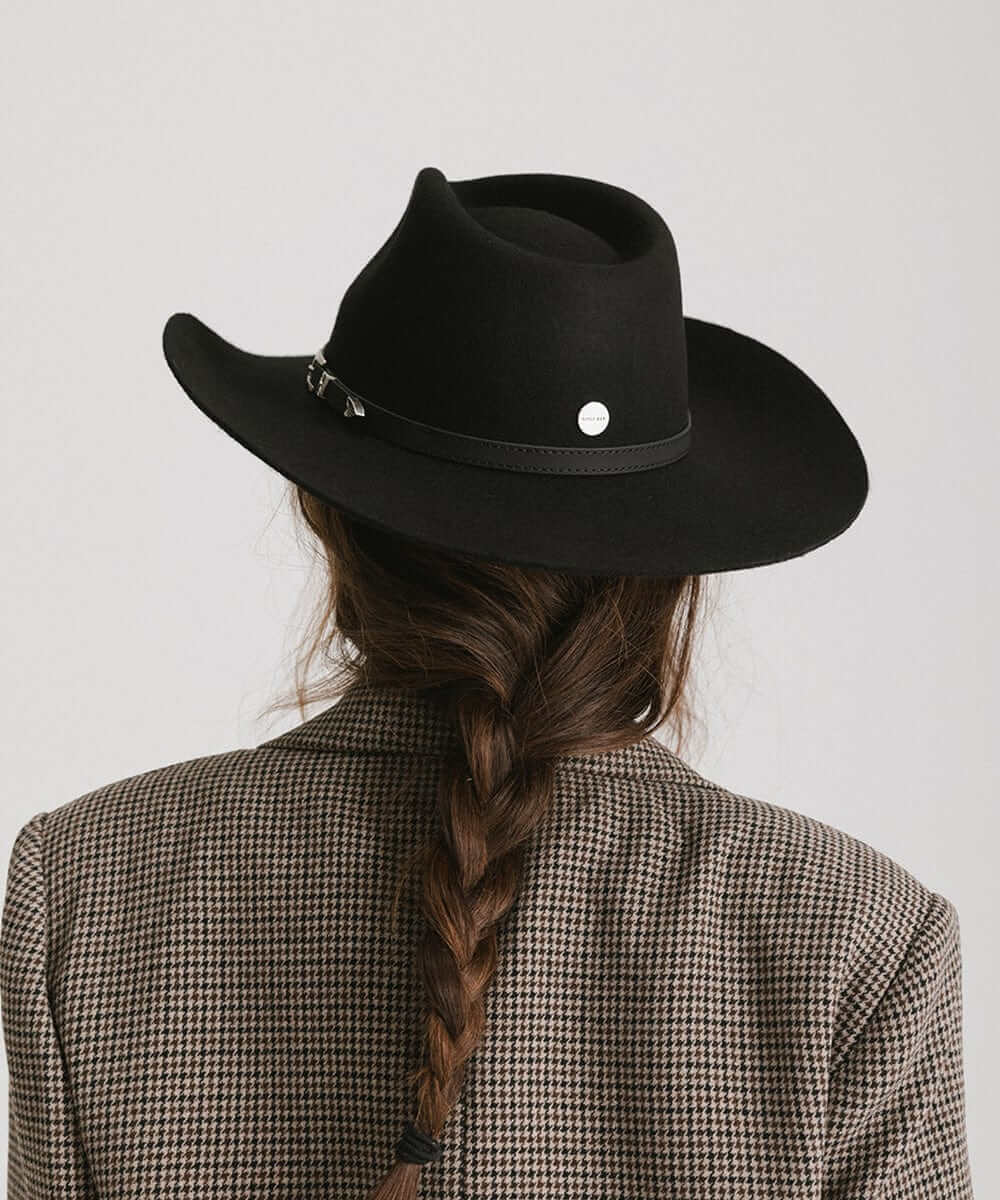 Back view of Dean Rancher Cowboy Hat on a woman with braided hair, showcasing its sculpted crown and leather band.