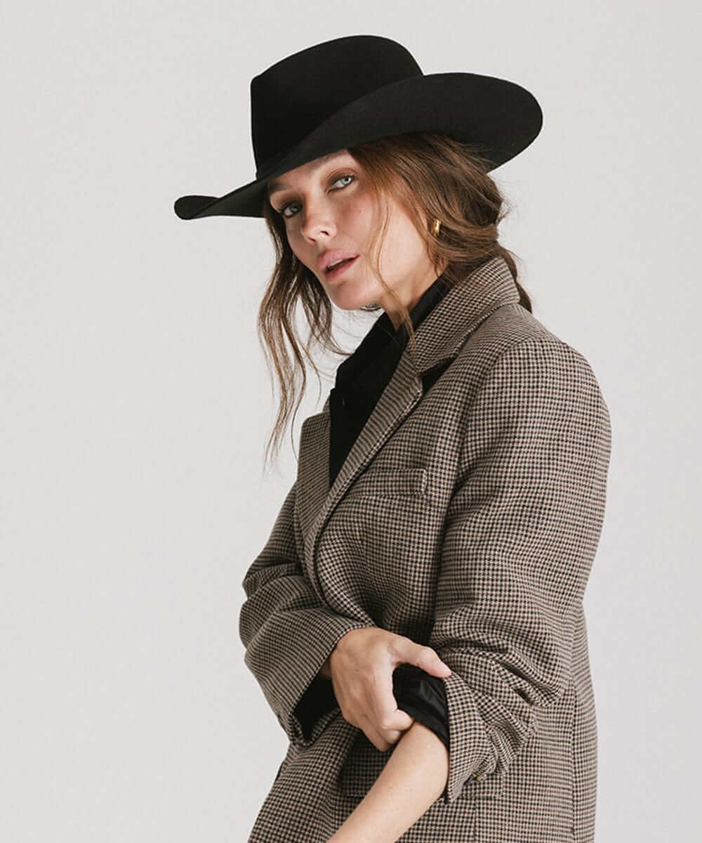 A woman wearing a Dean Rancher Cowboy Hat with a stylish blazer, showcasing Western fashion elegance.