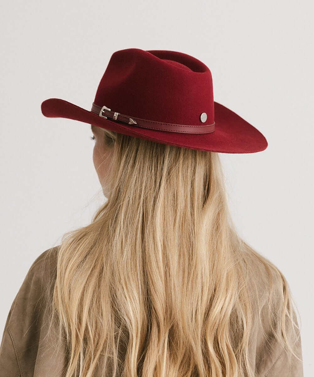 Dean Rancher Cowboy Hat in red with leather band, worn by a woman, showcasing stylish Western charm.