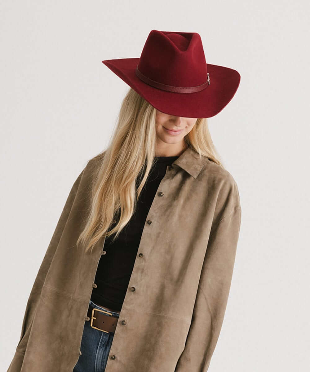 Dean Rancher Cowboy Hat in burgundy worn by a woman, showcasing Western style with a sculpted crown and leather band.