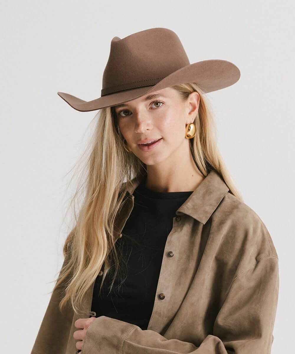 Stylish woman wearing the Dean Rancher Cowboy Hat with a sculpted crown and natural mid-length brim.