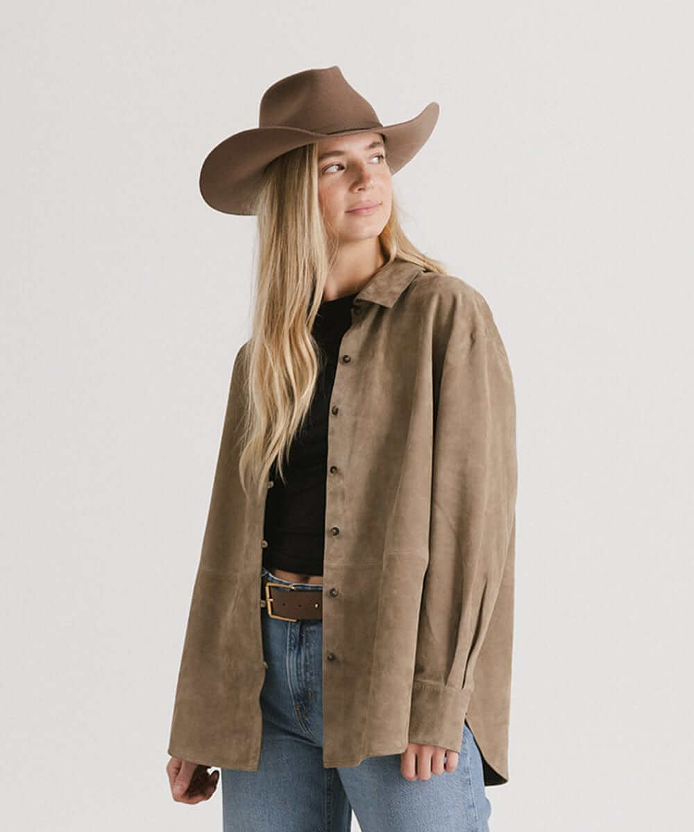 Woman wearing Dean Rancher Cowboy Hat paired with a stylish suede shirt, embodying Western charm and cowgirl style.