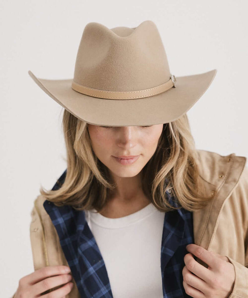 Woman wearing Dean Rancher Cowboy Hat, showcasing its sculpted crown and leather band, paired with a classic outfit.