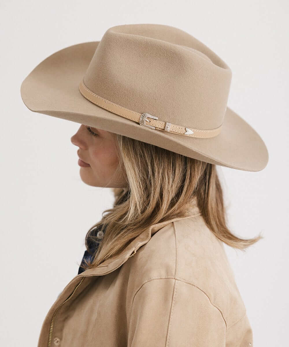 Dean Rancher Cowboy Hat in beige with leather band, showcased on a woman for stylish Western charm.