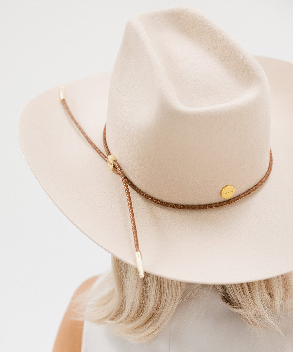 Lane Cowboy Hat with a brick top crown and braided leather band, stylishly worn from behind.