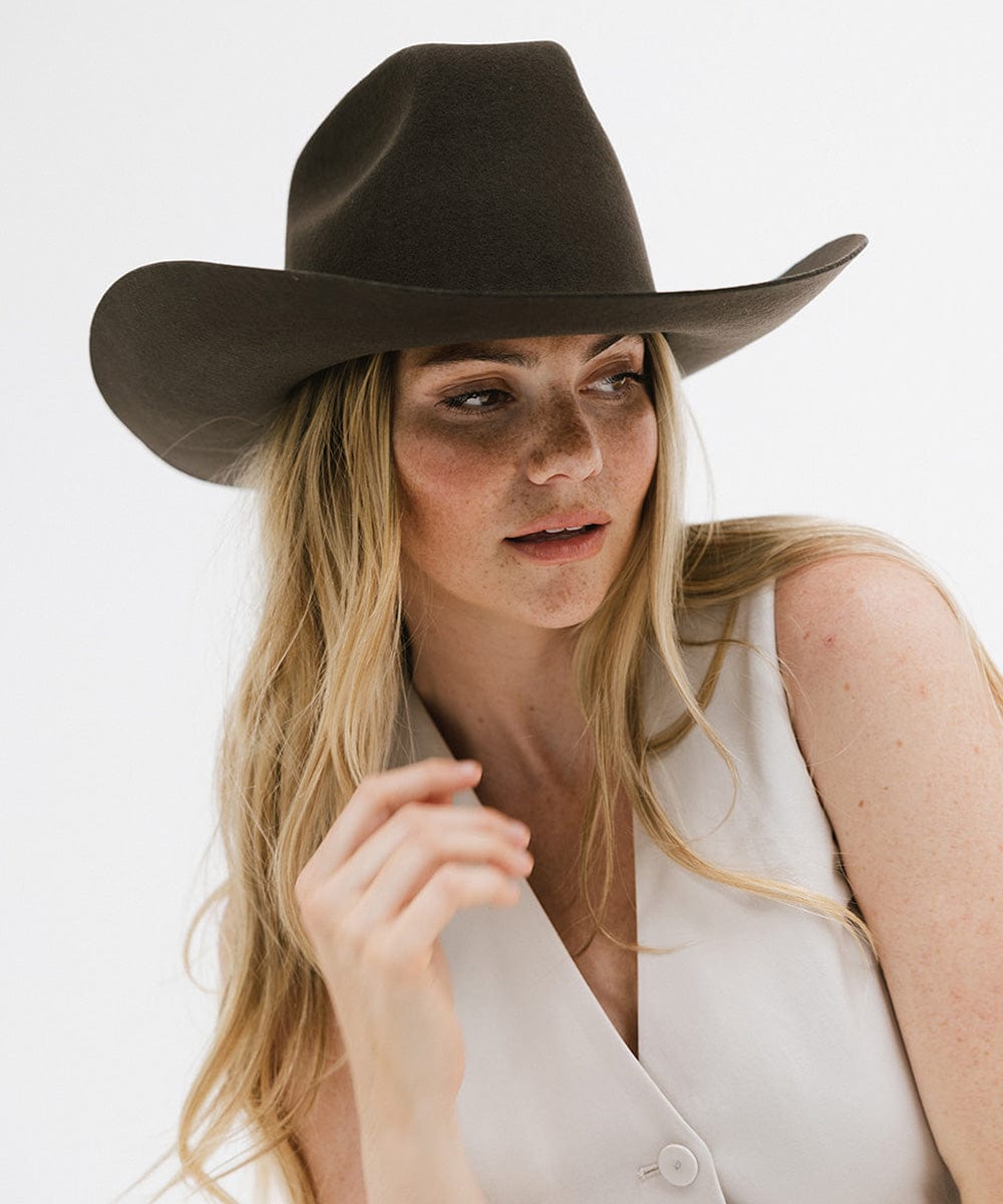 Model wearing Lane Cowboy Hat with a dark wide brim, showcasing a stylish and unique silhouette.
