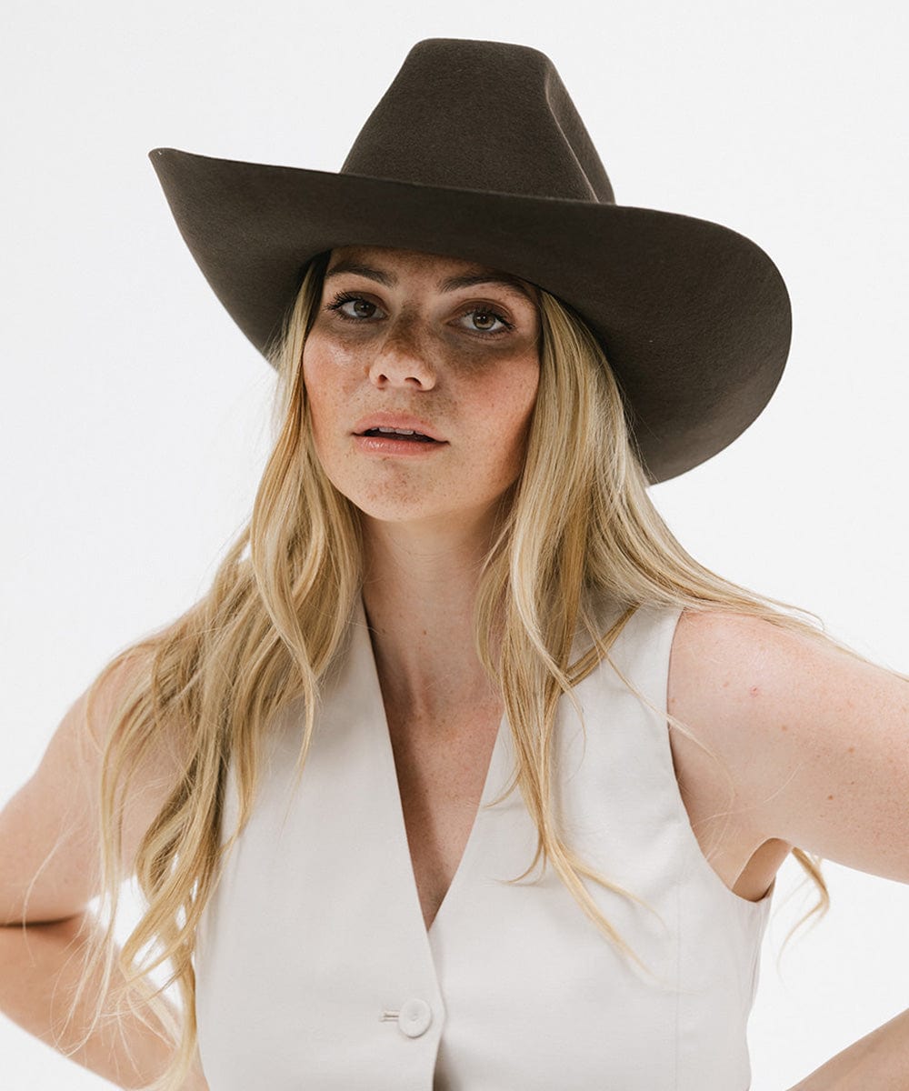 Model wearing the Lane Cowboy Hat with a stiff wide brim and unique crown, showcasing a bold Western style.
