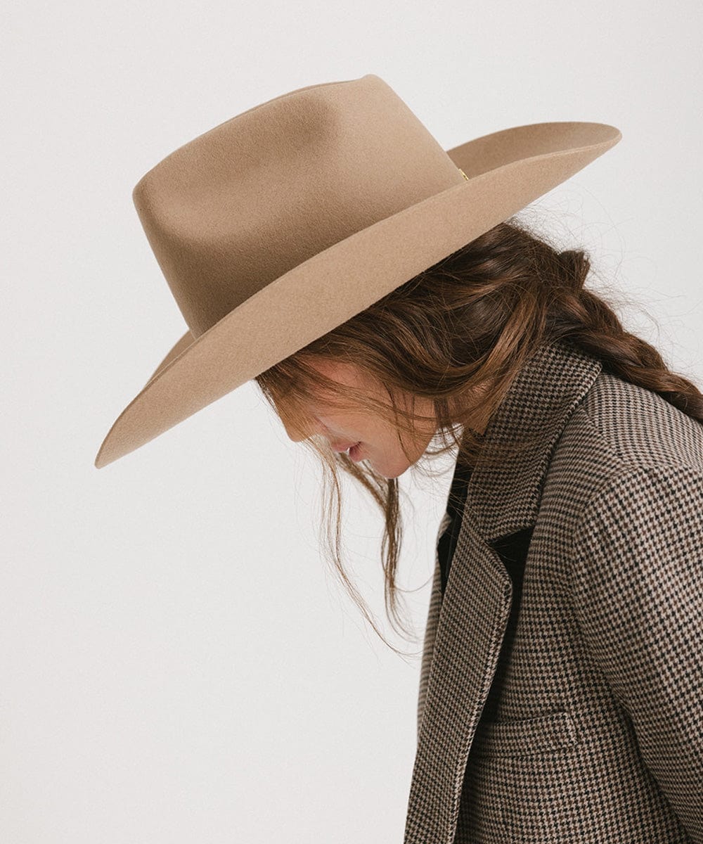 Profile view of a woman wearing a Lane Cowboy Hat with a wide brim, showcasing its stylish design and fit.