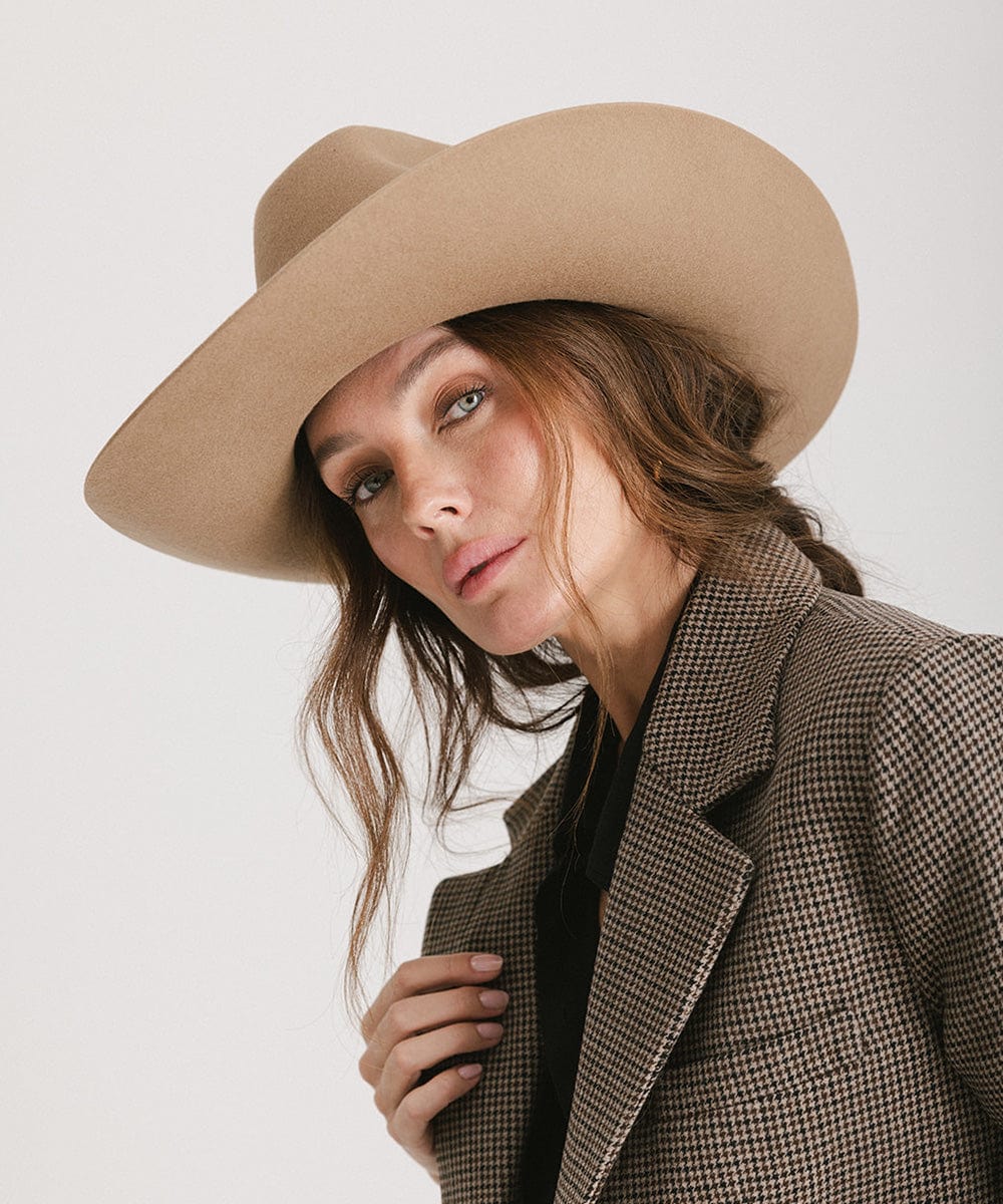 Model showcasing the Lane Cowboy Hat with a wide brim and unique brick crown design.