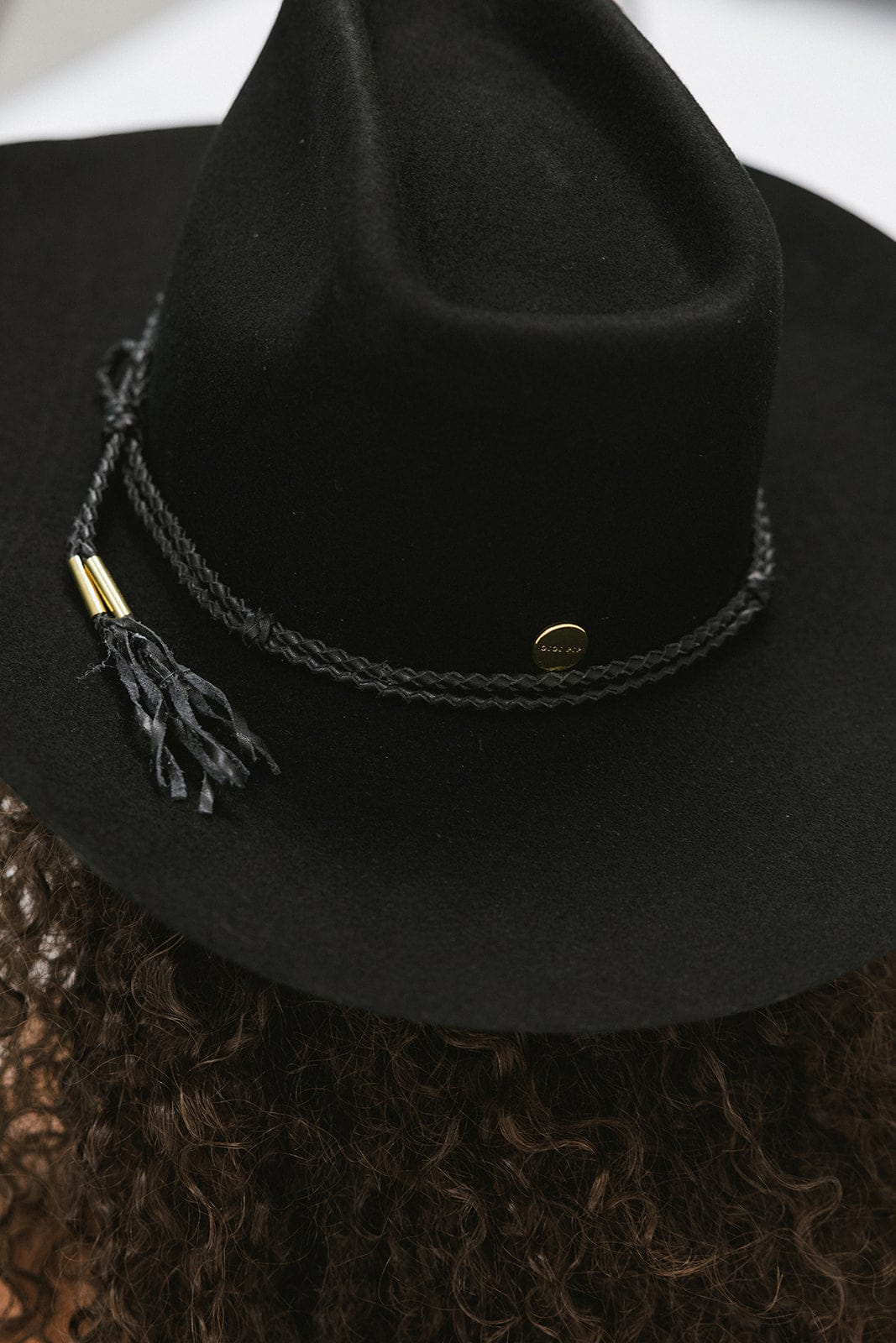 Close-up of Lane Cowboy Hat with black felt and braided black tassel band, showcasing unique design and craftsmanship.