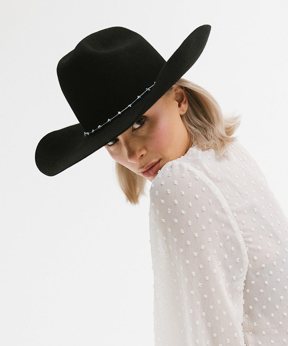Model wearing Teddy Cattleman Cowboy Hat with wide brim and classic cattleman crown, showcasing a stylish country look.