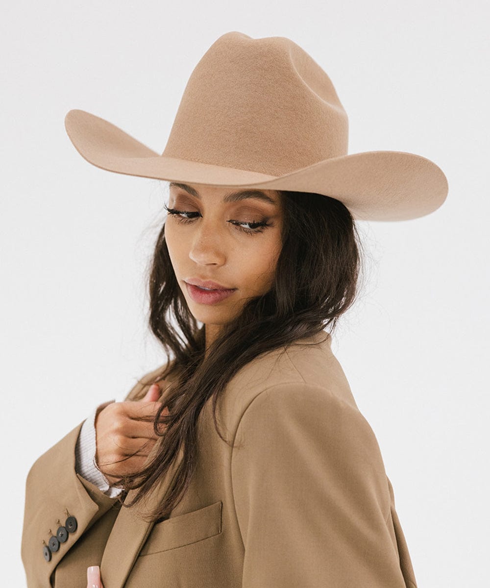 Stylish woman wearing a Teddy Cattleman cowboy hat with wide brim, showcasing classic western flair.