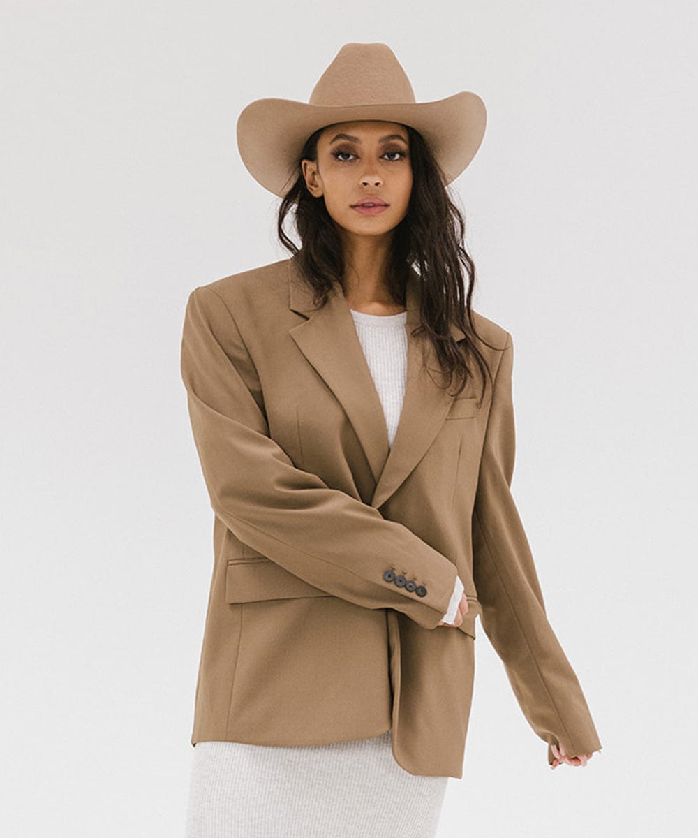 Model wearing a Teddy Cattleman Cowboy Hat with a stylish oversized blazer.