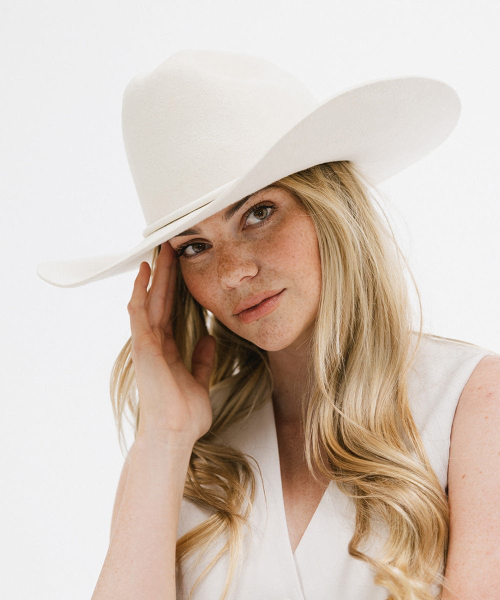Woman wearing a Teddy Cattleman cowboy hat, showcasing bold, timeless style for any occasion.