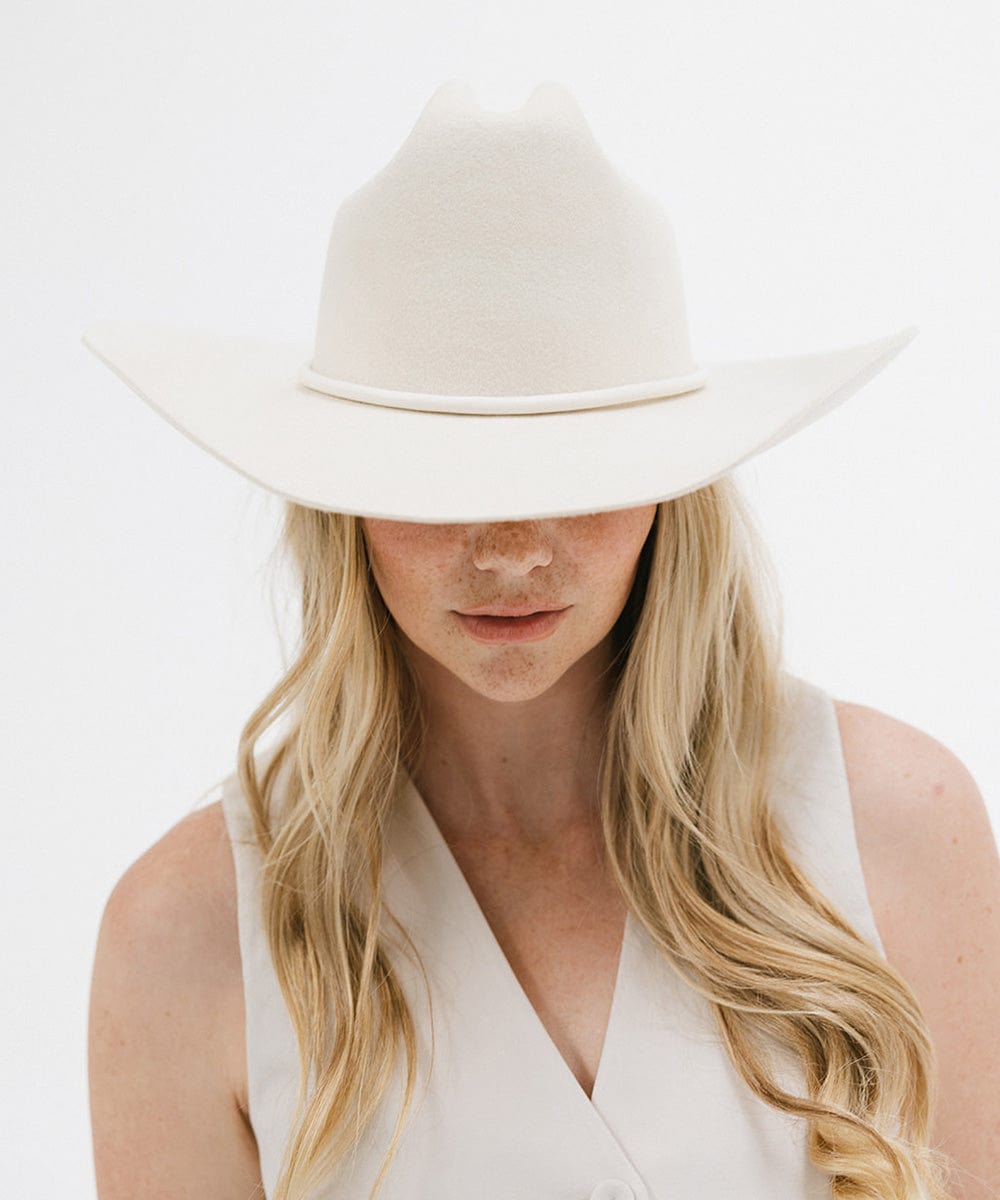 Stylish woman wearing a Teddy Cattleman cowboy hat, showcasing timeless western fashion.