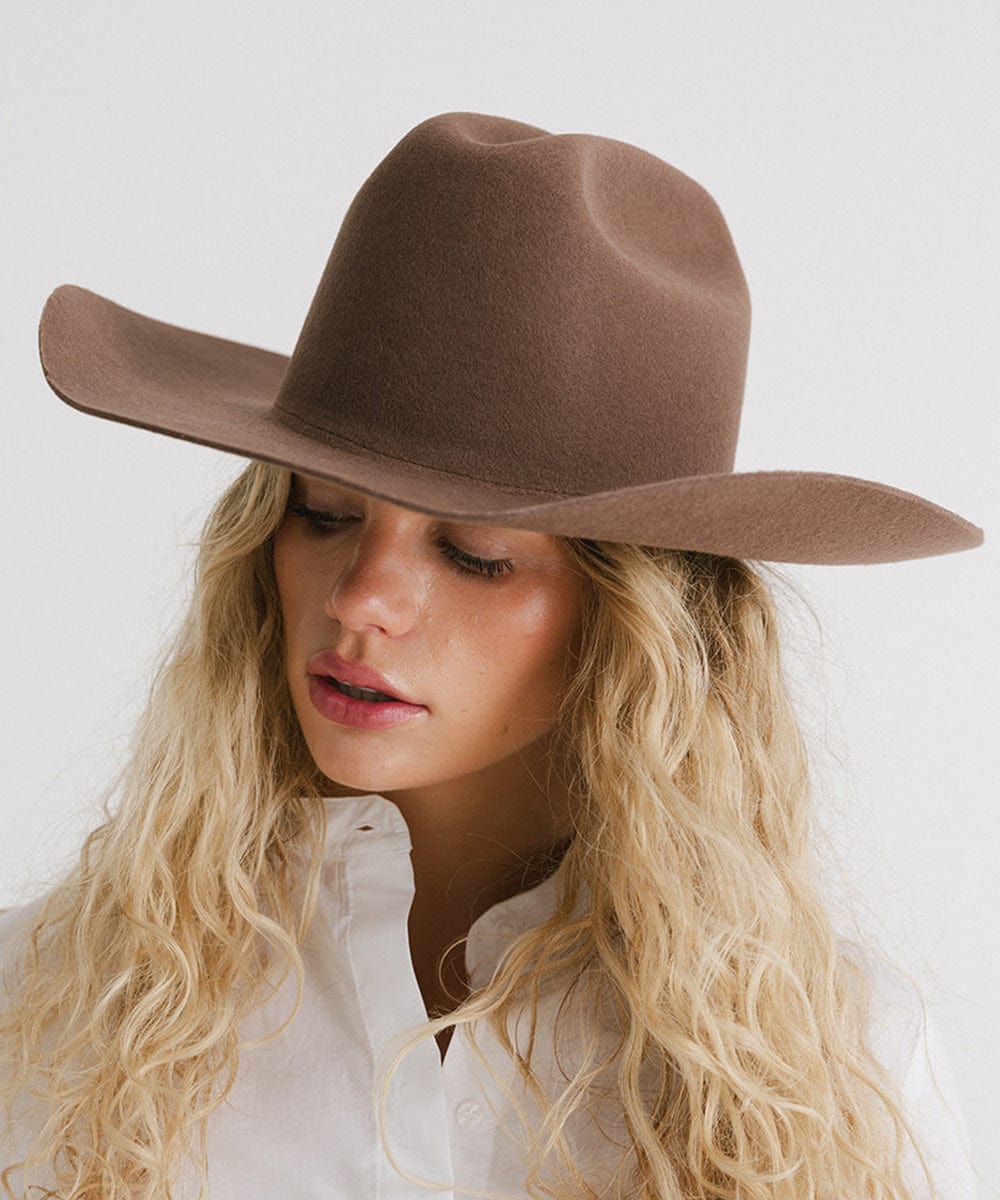 Stylish Teddy Cattleman cowboy hat on a model with curly hair, perfect for country festivals and casual outings.