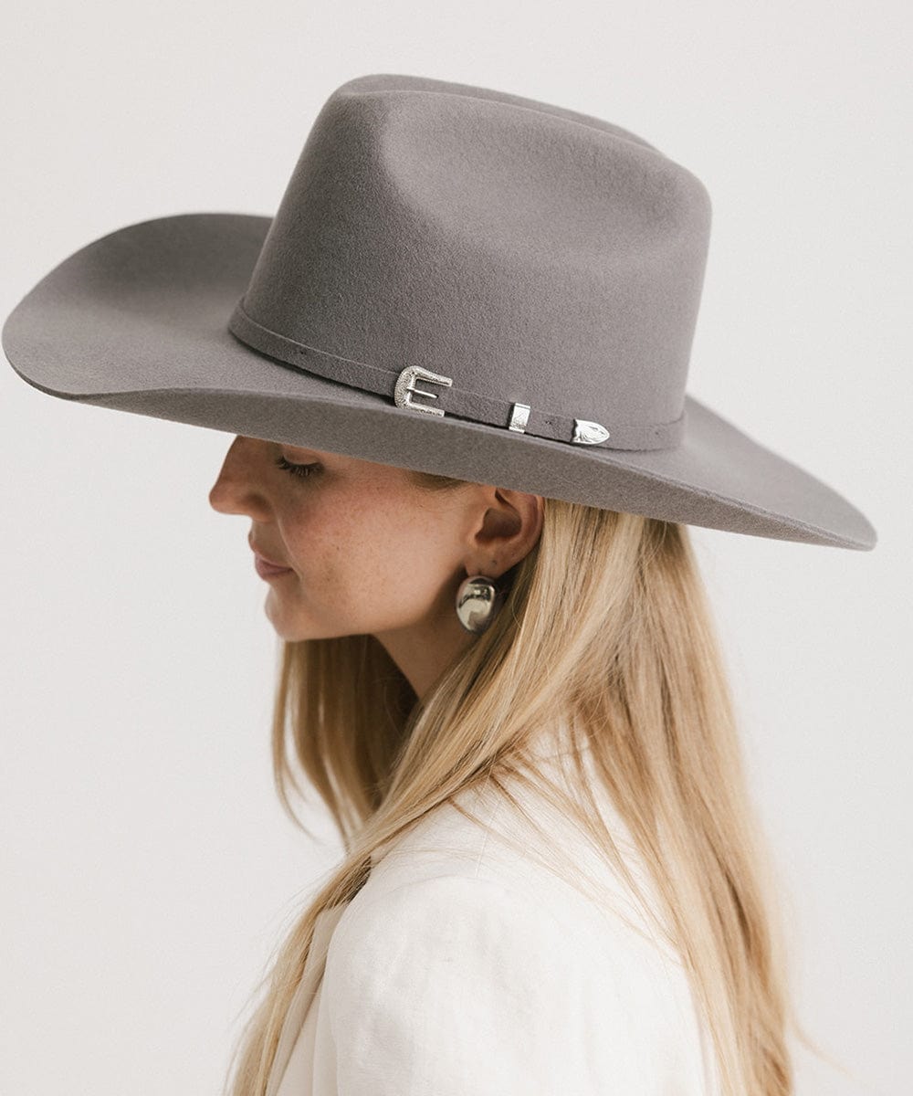 Stylish woman wearing a Teddy Cattleman Cowboy Hat in gray, showcasing its classic western design and chic elegance.