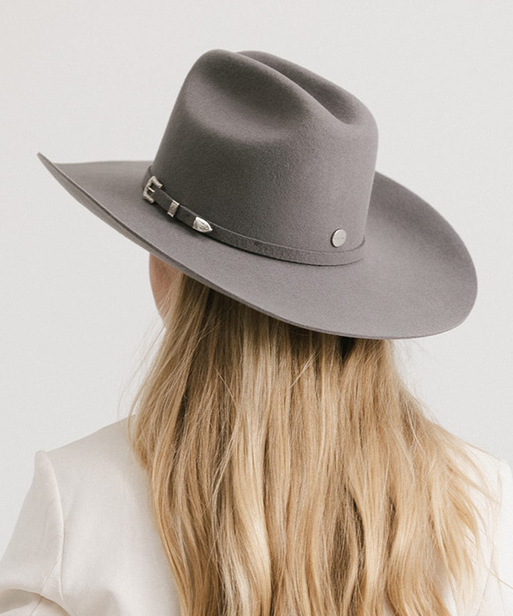 Woman wearing a gray Teddy Cattleman Cowboy Hat, showcasing its classic style and wide brim.