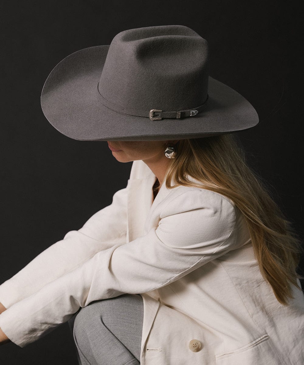 Stylish woman wearing a grey felt Teddy Cattleman cowboy hat, exuding timeless western charm.