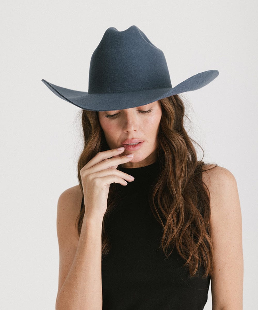 Woman in a stylish dark grey Teddy Cattleman cowboy hat, showcasing a classic western look.