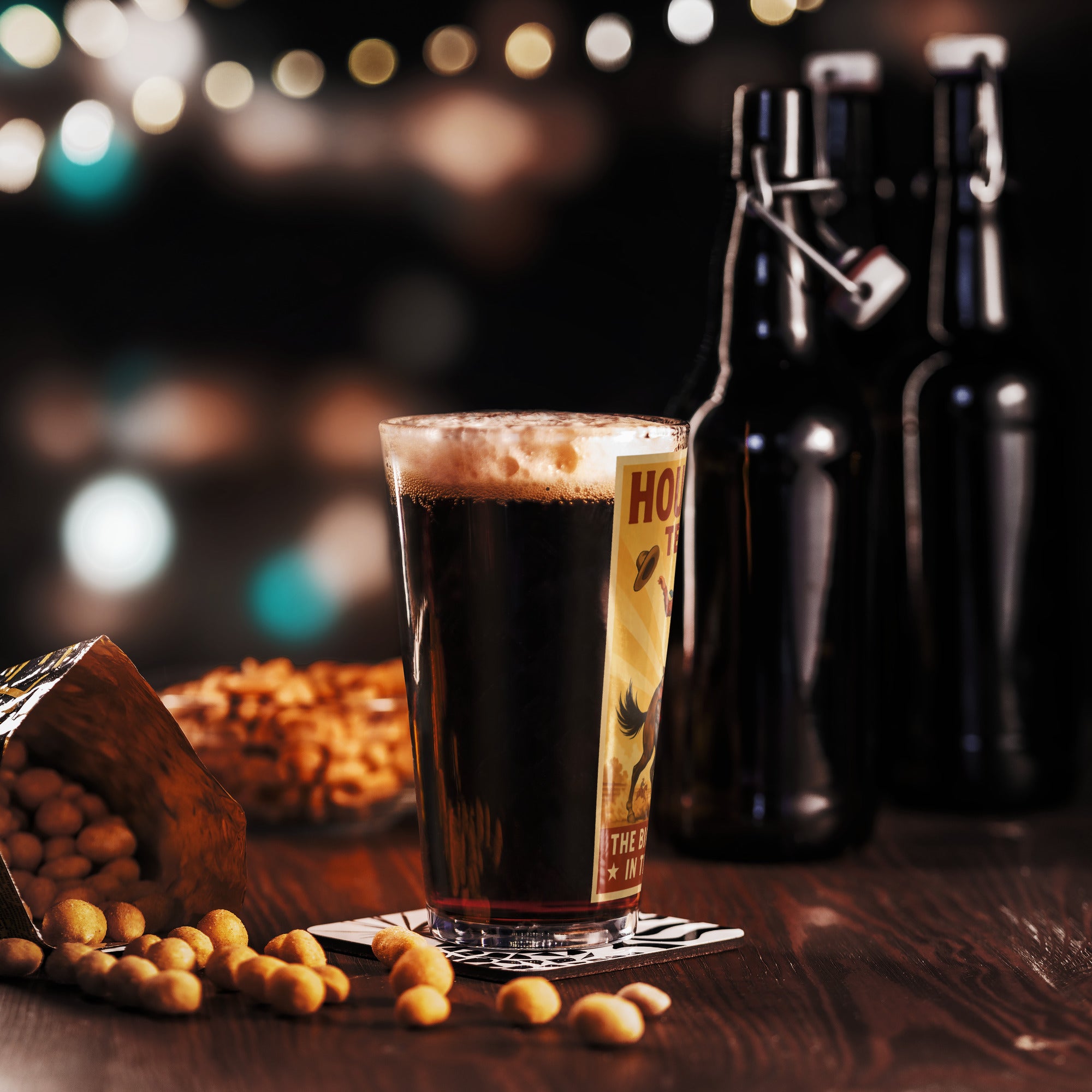 Vintage Houston Texas pint glass with beer, nuts, and dark bottles in a festive setting.