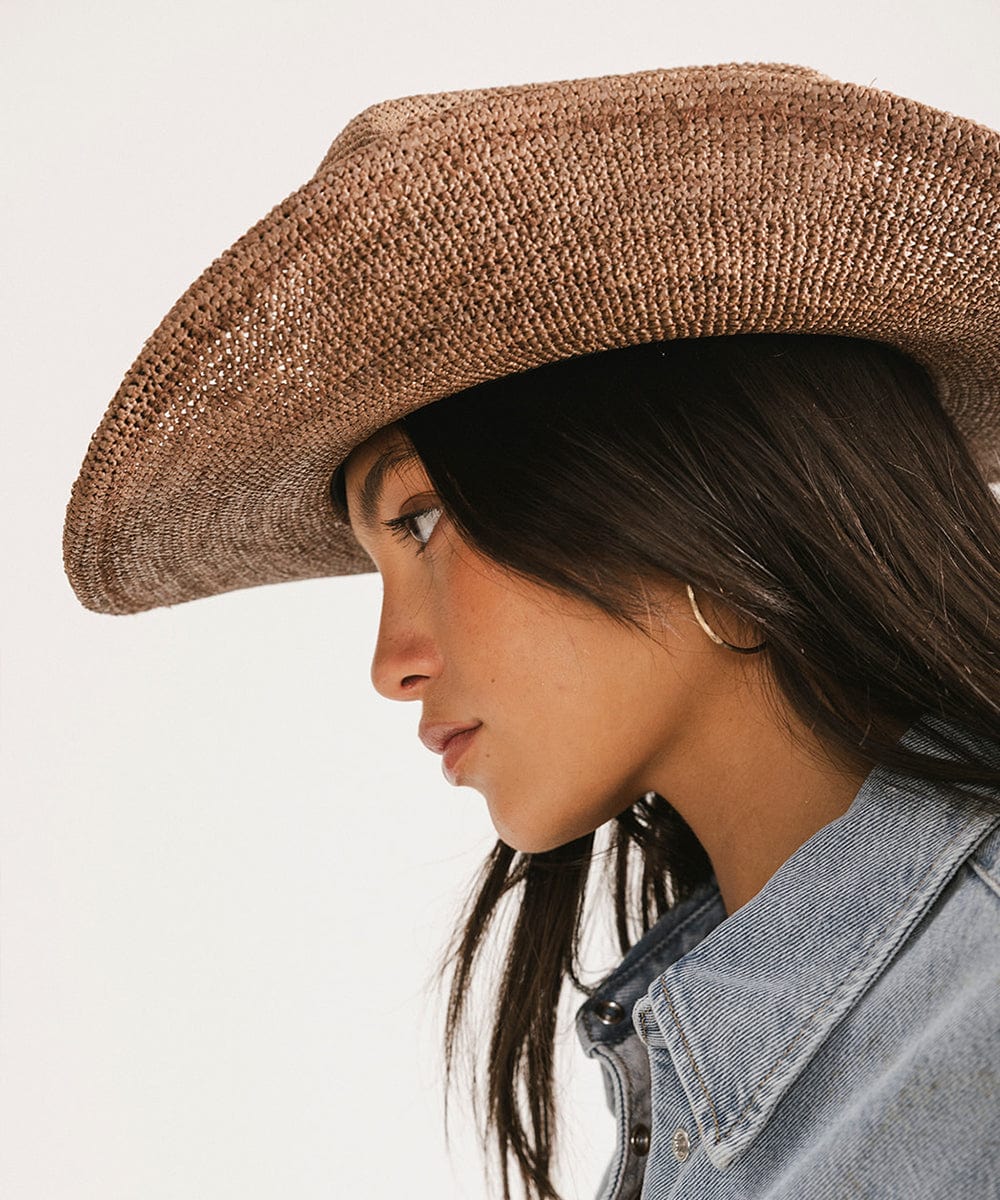 Ames Packable Straw Cowboy Hat showcased on a model, emphasizing its classic cattleman crown and breathable open-weave design.