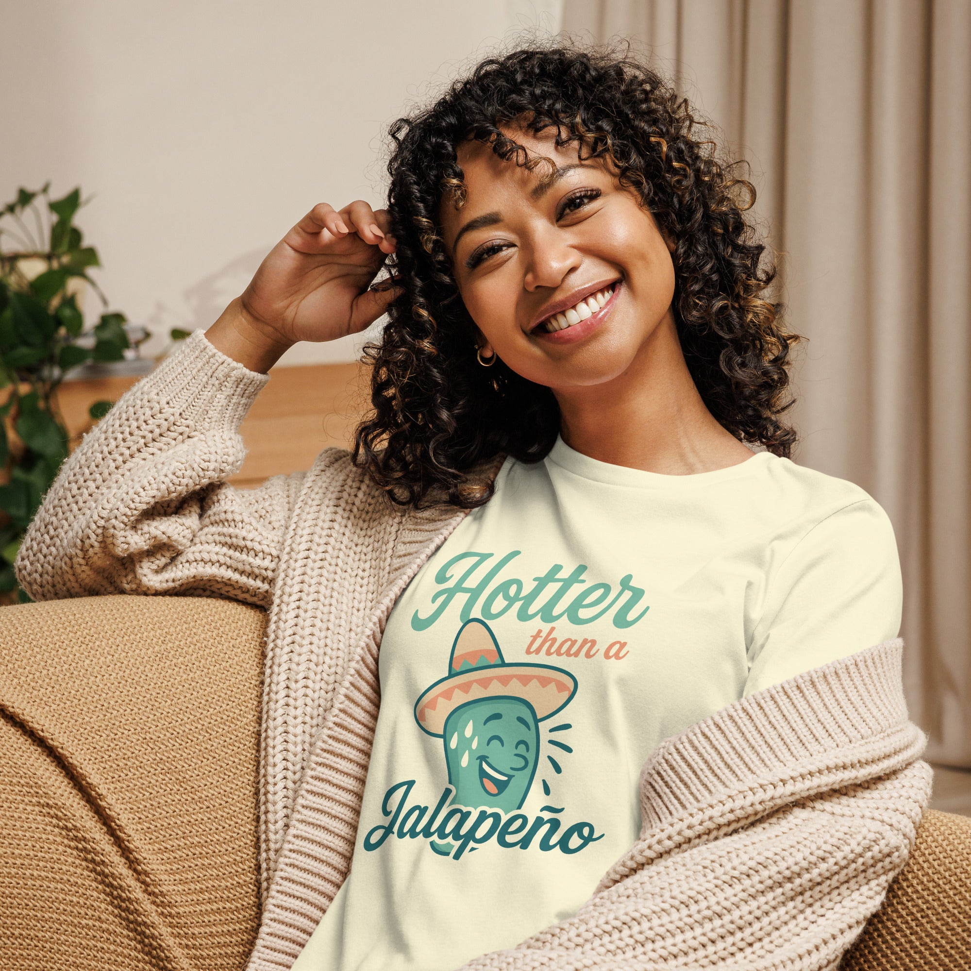 Smiling woman wearing 'Hotter Than a Jalapeño' graphic tee, showcasing fun design and comfy style.
